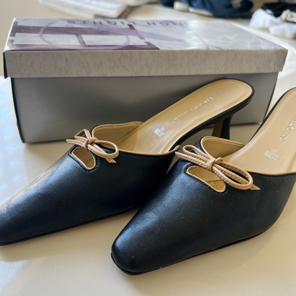Black mules with cream trim bow /kitten heel. Highlights brand .Never worn .